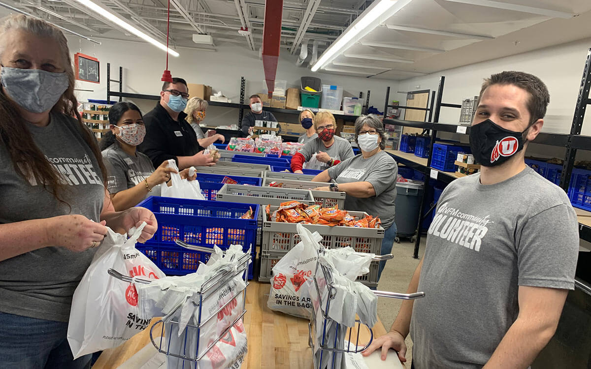 NFM employees helping bag lunches for kids in need